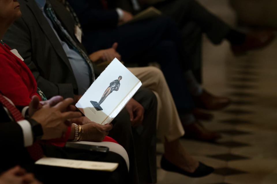 <div class="inline-image__caption"><p>An attendee holds a pamphlet displaying an Amelia Earhart statue before its unveiling in Statuary Hall at the U.S. Capitol on July 27, 2022.</p></div> <div class="inline-image__credit">Nathan Howard/Getty</div>