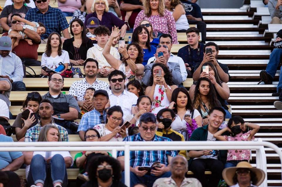 The crowd looks on during a commencement ceremony for the Merced College class of 2022 on the Don Odishoo Field at Stadium ’76 in Merced, Calif., on Friday, May 20, 2022.