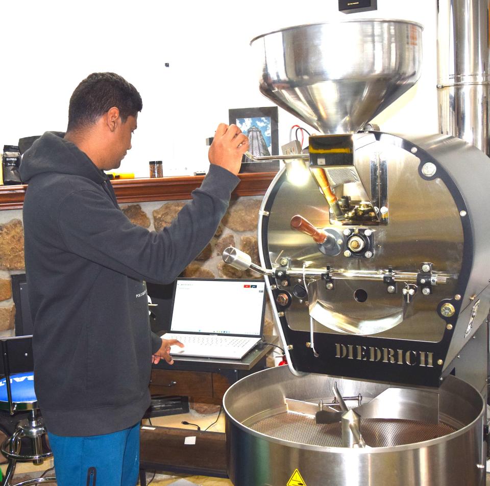 Sebastian Sanchez monitors the process of coffee beans being roasted at Millersburg Coffee Co.