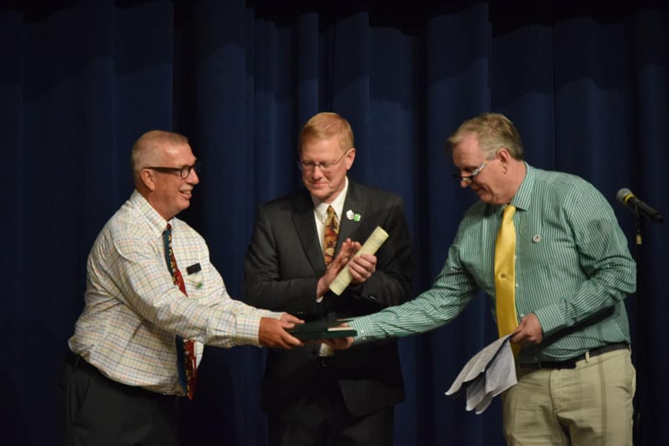 (From left) Boyne City Mayor Tom Neidhamer, Boyne City Manager Michael Cain and Trim Tourism Network Chair Mick Hughes exchange scrolls for the twinning in Boyne City during the official ceremony in 2019.