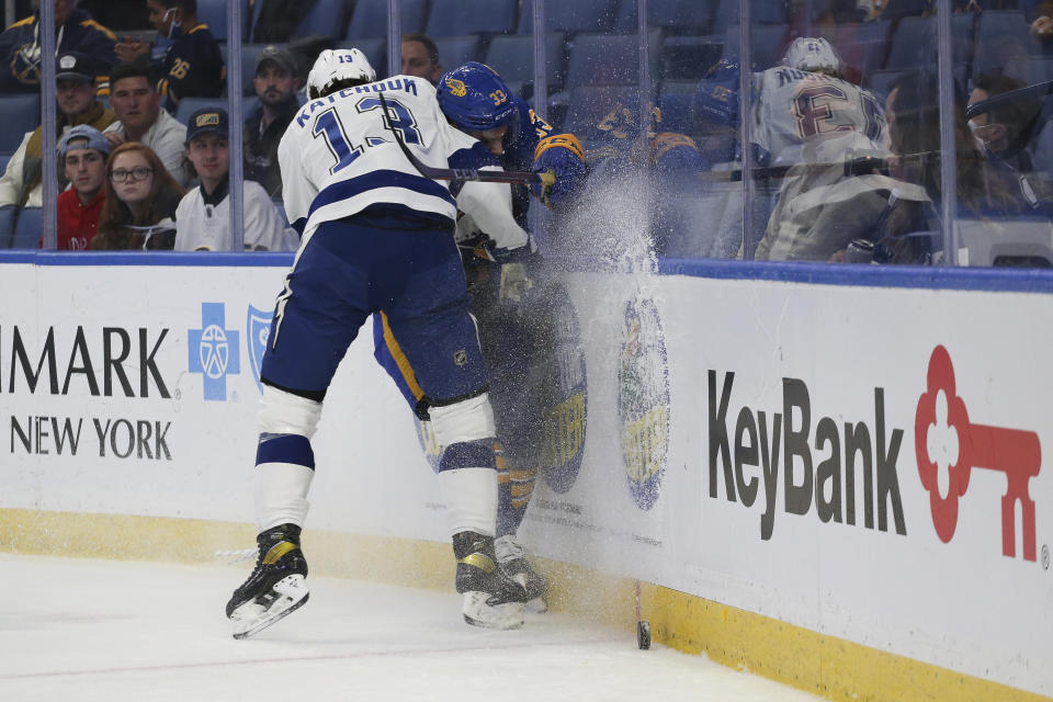 Tampa Bay Lightning left wing Boris Katchouk (13) checks Buffalo Sabres defenseman Colin Miller (33) during the first period of an NHL hockey game Monday, Oct. 25, 2021, in Buffalo, N.Y. (AP Photo/Joshua Bessex)