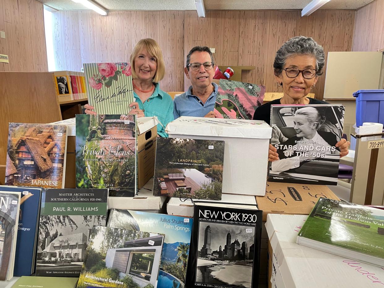 From left, Ginger Semple, Michael Hirschbein and Laura Miller hold some of their favorite books that will be available for purchase at the Architecture + Design Book Sale on Saturday, Oct. 21 at the Palm Springs Public Library.