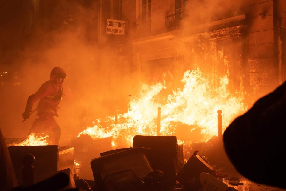 Firefighters battled blazes in Paris after rioters set uncollected rubbish alight (AFP via Getty)