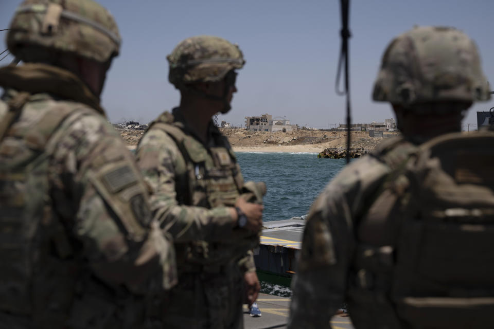 U.S. Army soldiers stand at the U.S.-built floating pier Trident backdropped by the coast of the Gaza Strip, Tuesday, June 25, 2024. (AP Photo/Leo Correa)