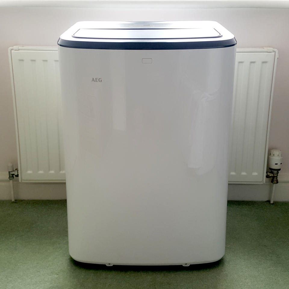 The AEG Comfort 6000 Portable Air Conditioner being tested in a room with green carpet