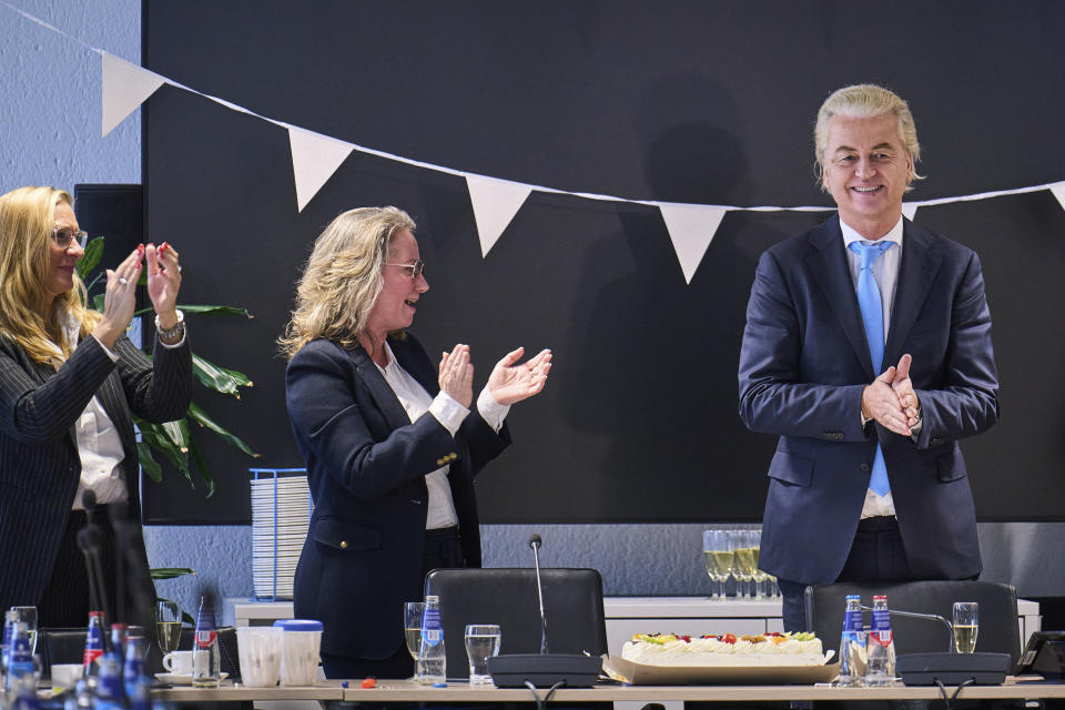 Far-right Party for Freedom leader Geert Wilders, right, celebrates with Fleur Agema, section left, and other party members after winning the most votes in a general election, in The Hague, Netherlands, Thursday Nov. 23, 2023. (AP Photo/Phil Nijhuis)