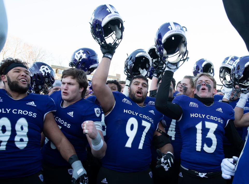 Holy Cross players celebrate their win over Sacred Heart University at Fitton Field.