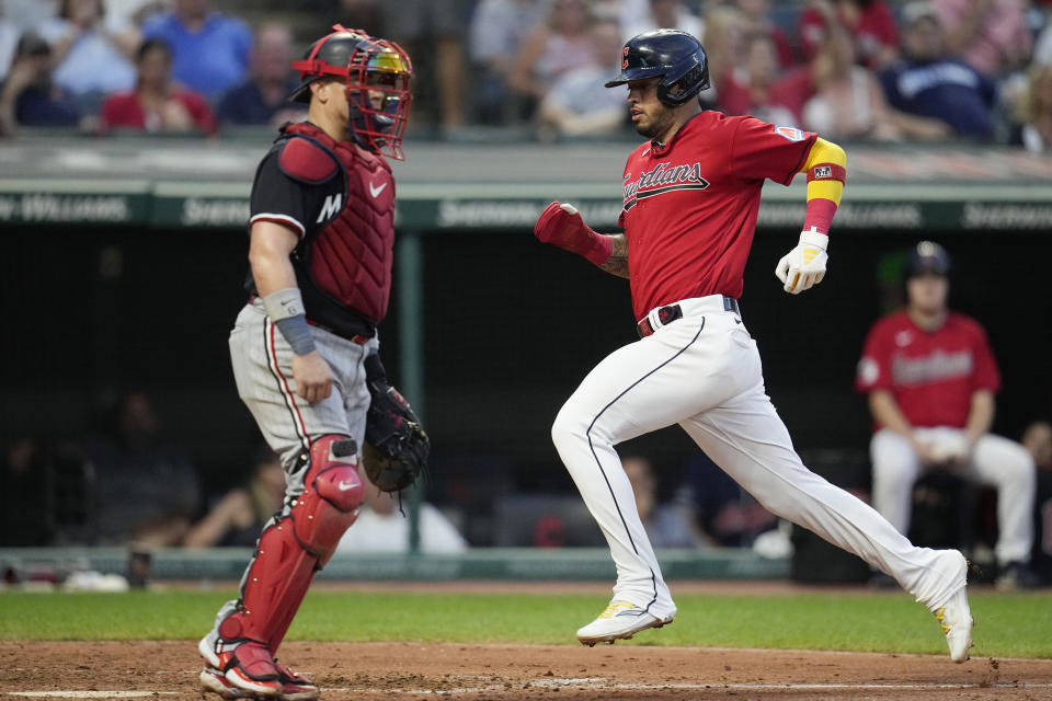 Cleveland Guardians' Gabriel Arias, right, scores behind Minnesota Twins catcher Christian Vázquez, left, in the fifth inning of a baseball game Tuesday, Sept. 5, 2023, in Cleveland. (AP Photo/Sue Ogrocki)