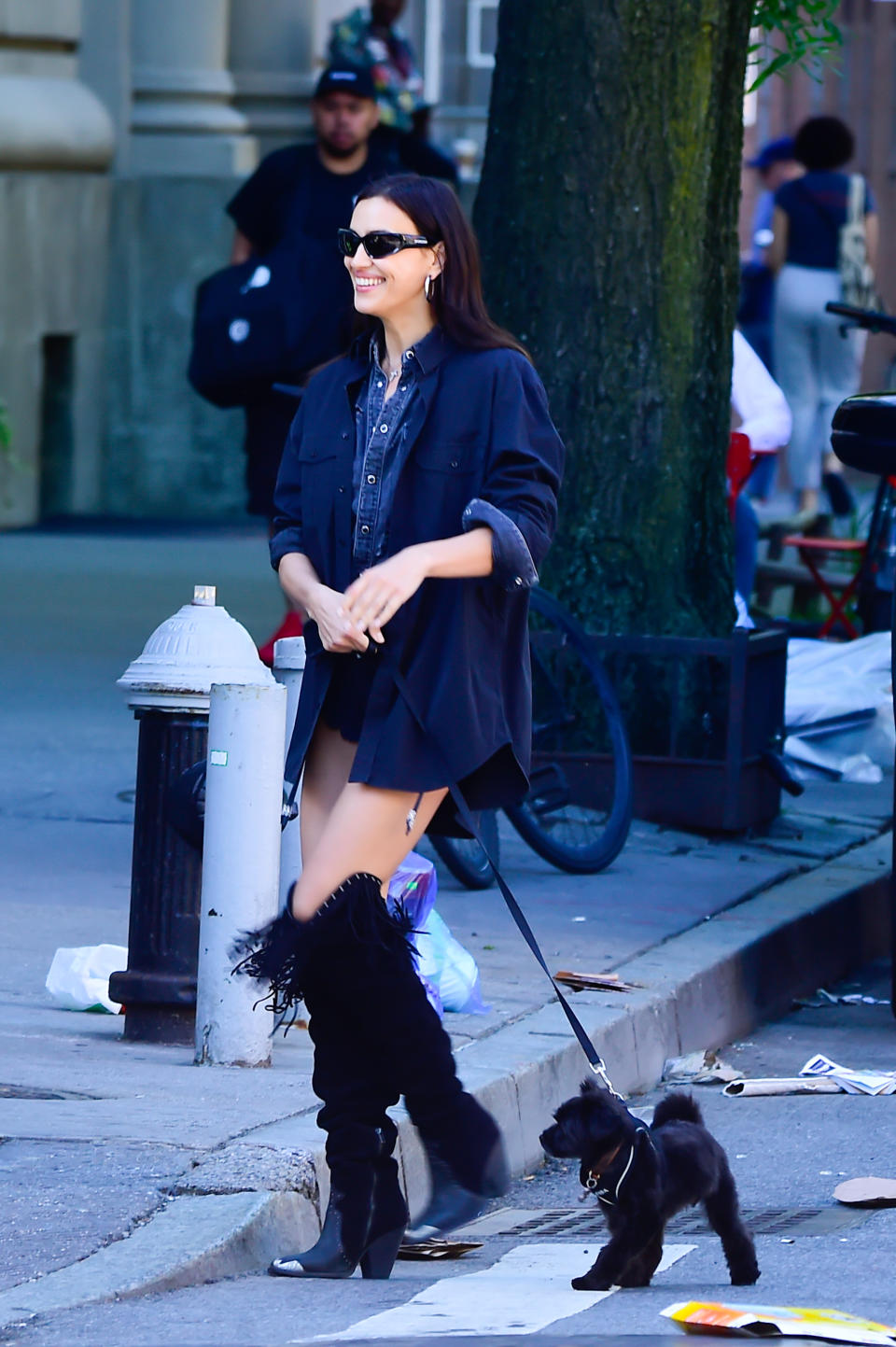 Irina Shayk is seen walking in Soho in New York City wearing leather boots and matching leg warmers.