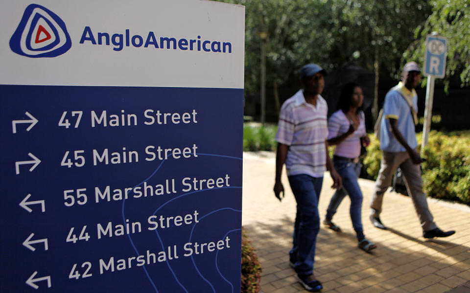 People walk past a board outside the Anglo American offices in Johannesburg, South Africa. Photo: Siphiwe Sibeko/Reuters