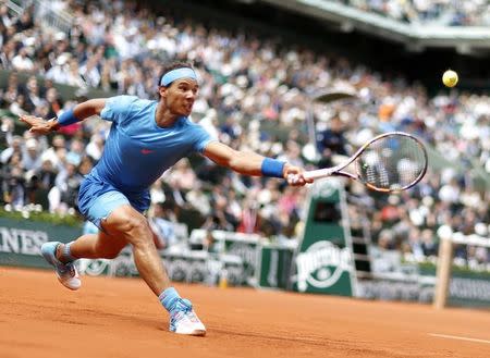 Rafael Nadal of Spain plays a shot to compatriot Nicolas Almagro during their men's singles match at the French Open tennis tournament at the Roland Garros stadium in Paris, France, May 28, 2015. REUTERS/Vincent Kessler