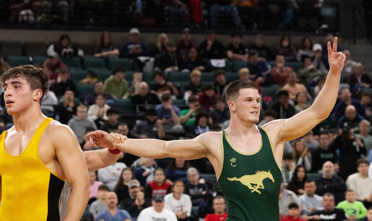 Brick Memorial's Harvey Ludington celebrates after he defeated Hanover Park's Vincenzo LaValle 11-3 in the 190-pound  state final.