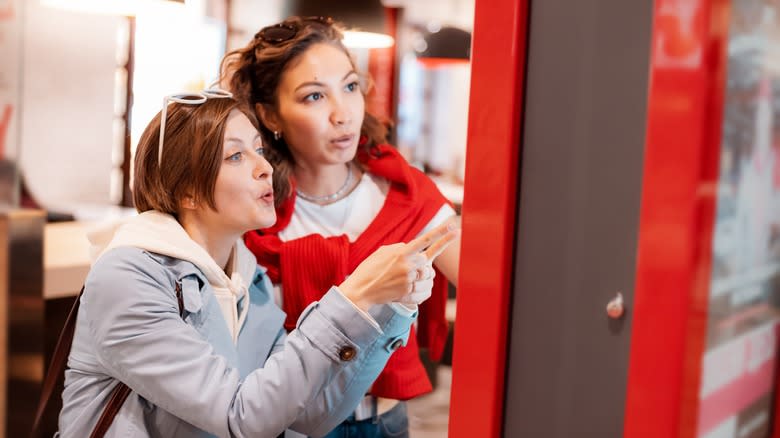 ladies ordering from menu kiosk