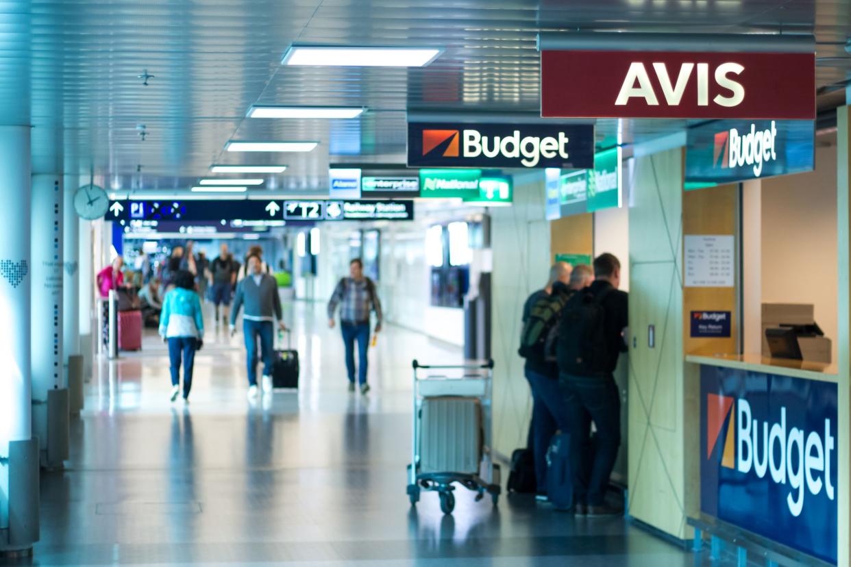 Vantaa, Finland June 12, 2019 - Car rental agencies in Helsinki Airport - Blurred people waitin on the the desk