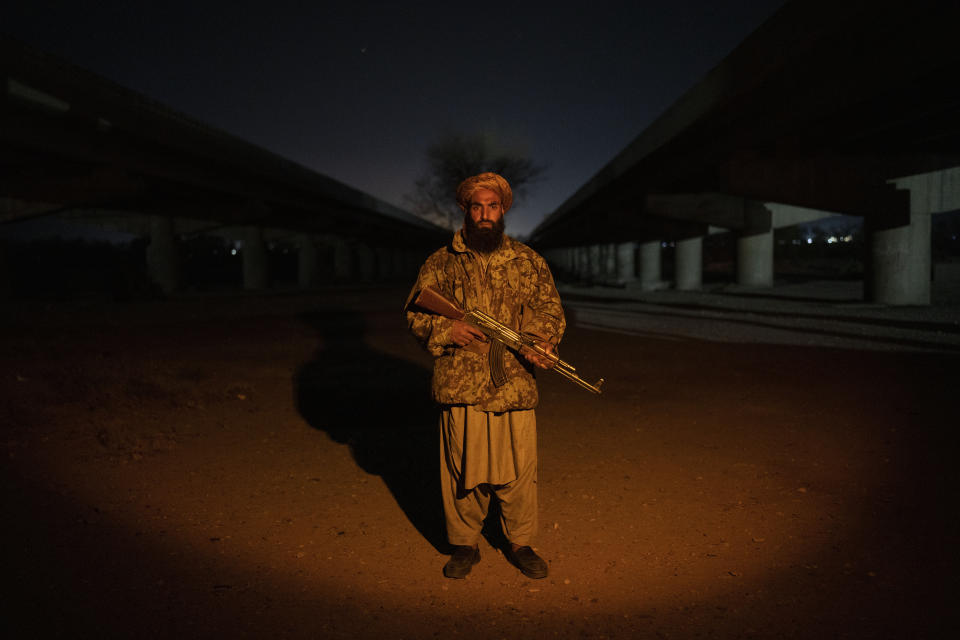 A Taliban fighter poses for a photo at check point in Herat Afghanistan, on Monday, Nov. 29, 2021. Since the Taliban's takeover of Afghanistan just over three months ago amid a chaotic withdrawal of U.S. and NATO troops, its fighters have changed roles, turning from fighting in the mountains and the fields to running the country. (AP Photo/ Petros Giannakouris)