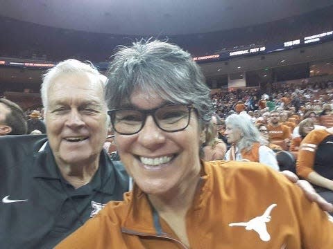 Jamie Smith, with her father Bubba at a UT women's basketball game, scored more than 3,400 points in her four years at McCallum High School. The school retired her No. 22 jersey in a recent ceremony.