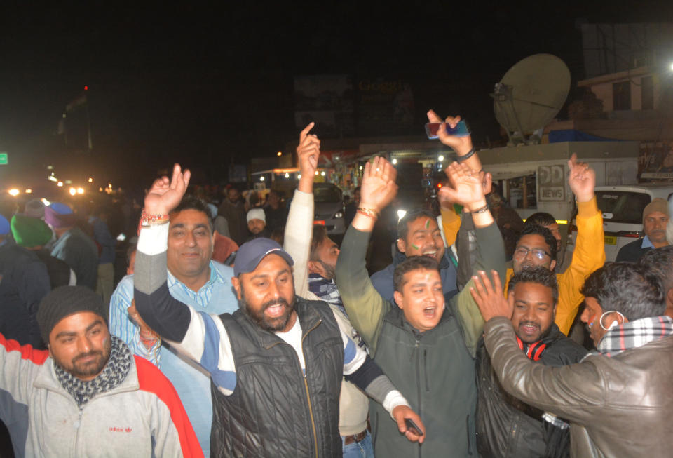 Indians celebrate after the convoy carrying Indian air force Wing Commander Abhinandan Varthaman entered the Indian side of the border in Attari, India, Friday, March 1, 2019. Pakistani officials handed over the captured Indian pilot to a border crossing with India on Friday in a "gesture of peace" promised by Pakistani Prime Minister Imran Khan amid a dramatic escalation with the country's archrival over the disputed region of Kashmir. (AP Photo/Prabhjot Gill)