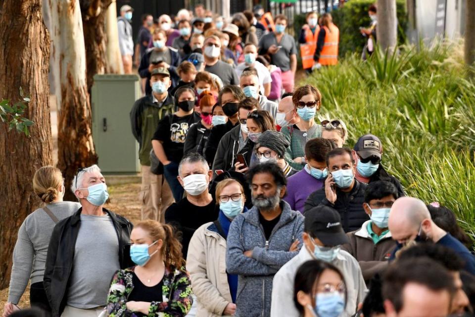 Sydneysiders queue outside a vaccination centre in Sydney.