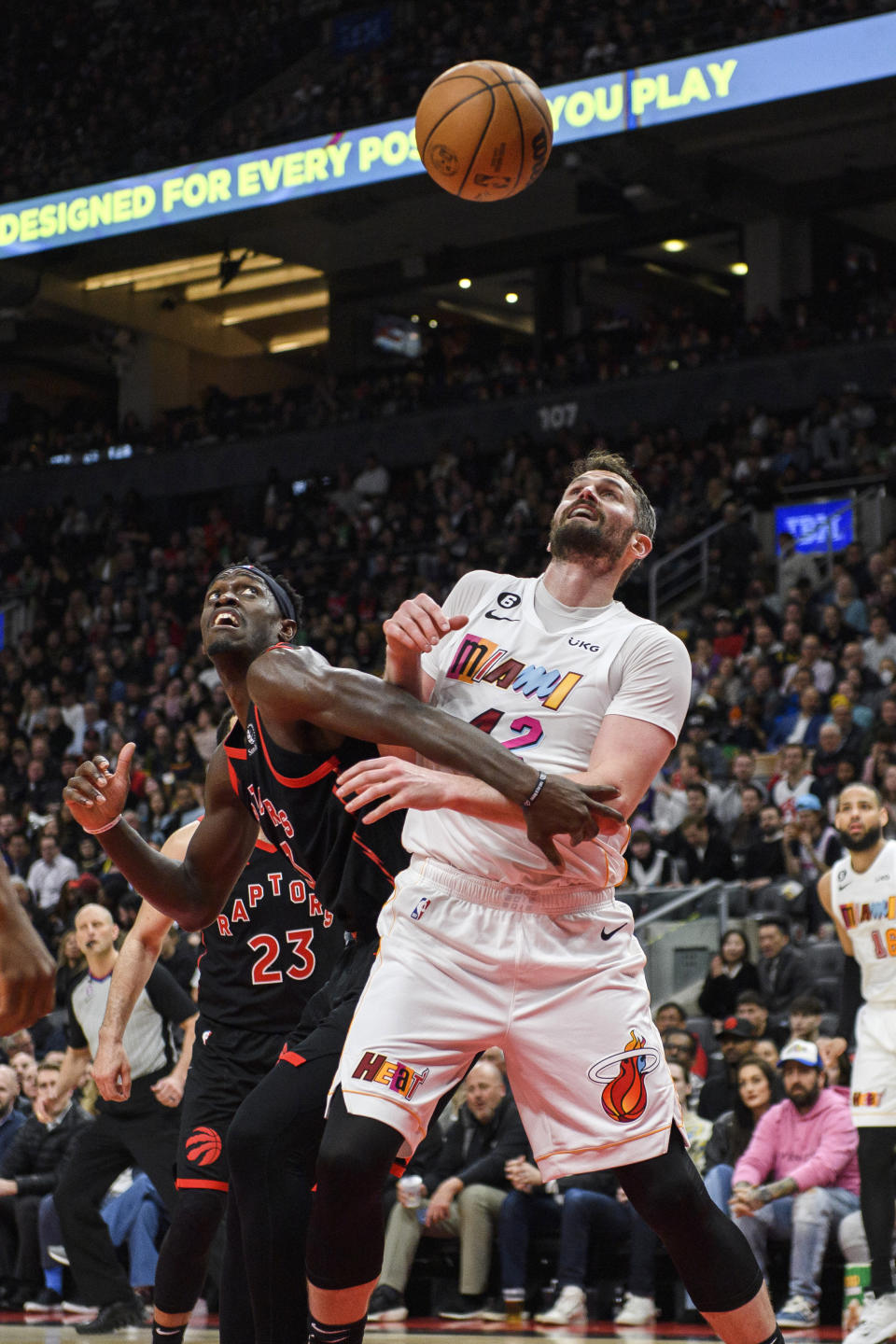 Toronto Raptors forward Pascal Siakam (43) and Miami Heat forward Kevin Love (42) look up for the ball during the second half of an NBA basketball game Tuesday, March 28, 2023, in Toronto. (Christopher Katsarov/The Canadian Press via AP)