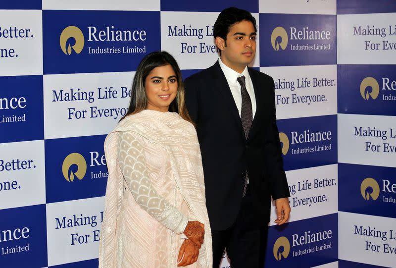 Isha Ambani and Akash Ambani, children of Mukesh Ambani, Chairman and Managing Director of Reliance Industries, pose for a photograph as they arrive to attend the company's annual general meeting in Mumbai