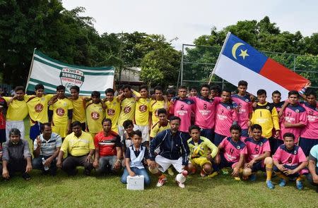 A group of young refugees footballers pose for a photo before a match in Kuala Lumpur, Malaysia, August 14, 2016. Picture taken on August 14, 2016. REUTERS/Beh Lih Yi