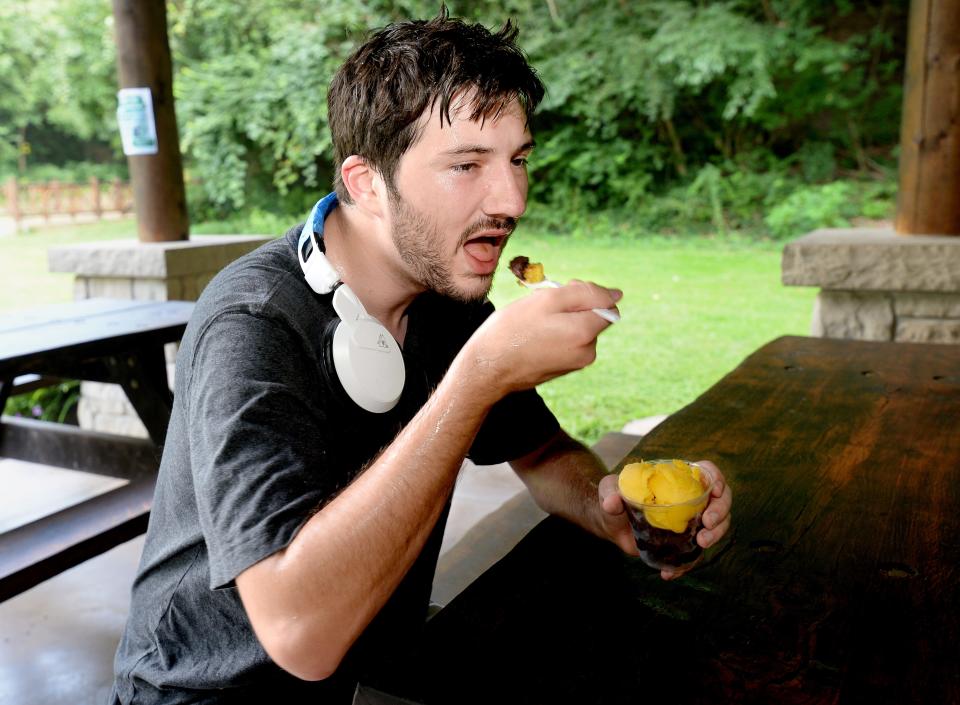 Nicholis Shishkoff, of Springfield cools off from the heat with a frozen treat at Park-N-Chill in Washington Park after riding his bike around the park in Springfield Wednesday, August 23, 2023.