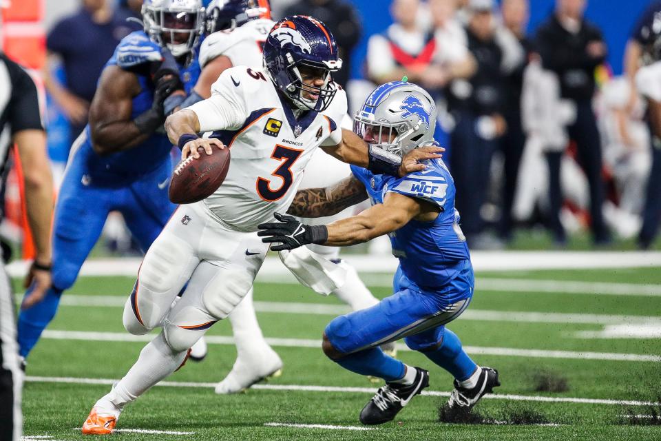 Detroit Lions safety Brian Branch (32) tackles Denver Broncos quarterback Russell Wilson (3) during the second half at Ford Field in Detroit on Saturday, Dec. 16, 2023.