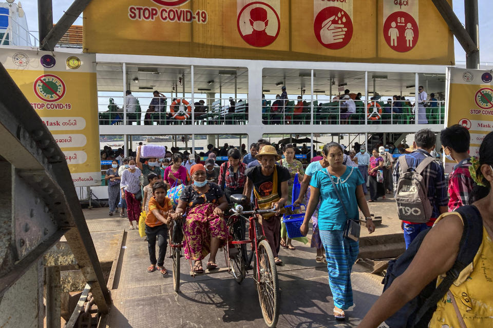 People disembark from a ferry at the Pansodan jetty in Yangon, Myanmar on Nov. 12, 2021. The military takeover in Myanmar has set its economy back years, if not decades, as political unrest and violence disrupt banking, trade and livelihoods and millions slide deeper into poverty. (AP Photo)