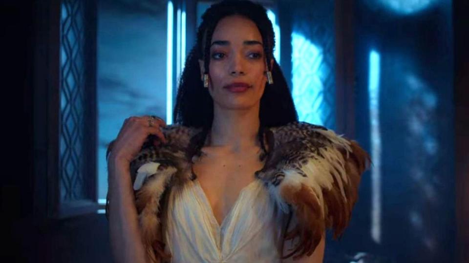 cassie clare as philippa in the witcher, wearing a white outfit with bird wing esque shoulders