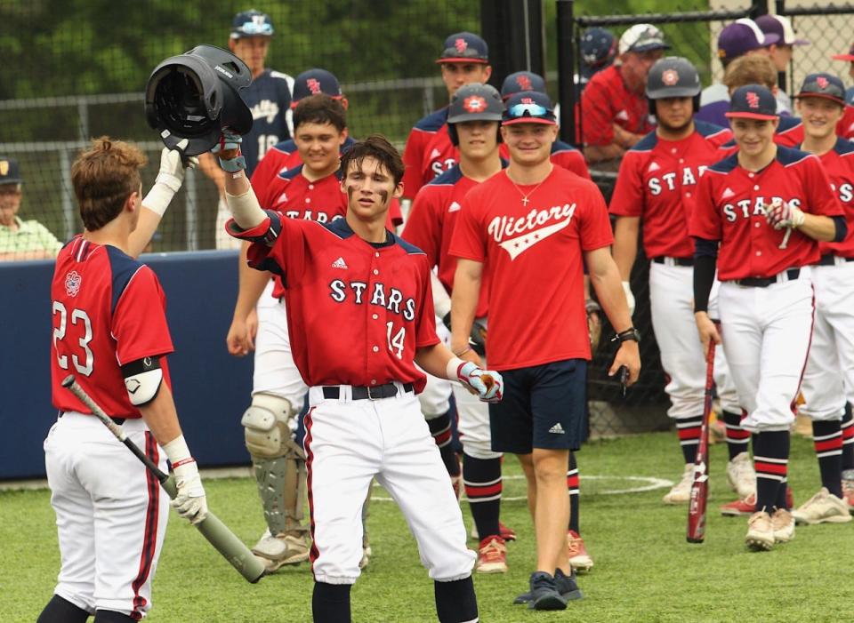 BNL senior Grant Dalton (14) taps helmets with Walker Ward (23) to celebrate Dalton's home run on Senior Day.