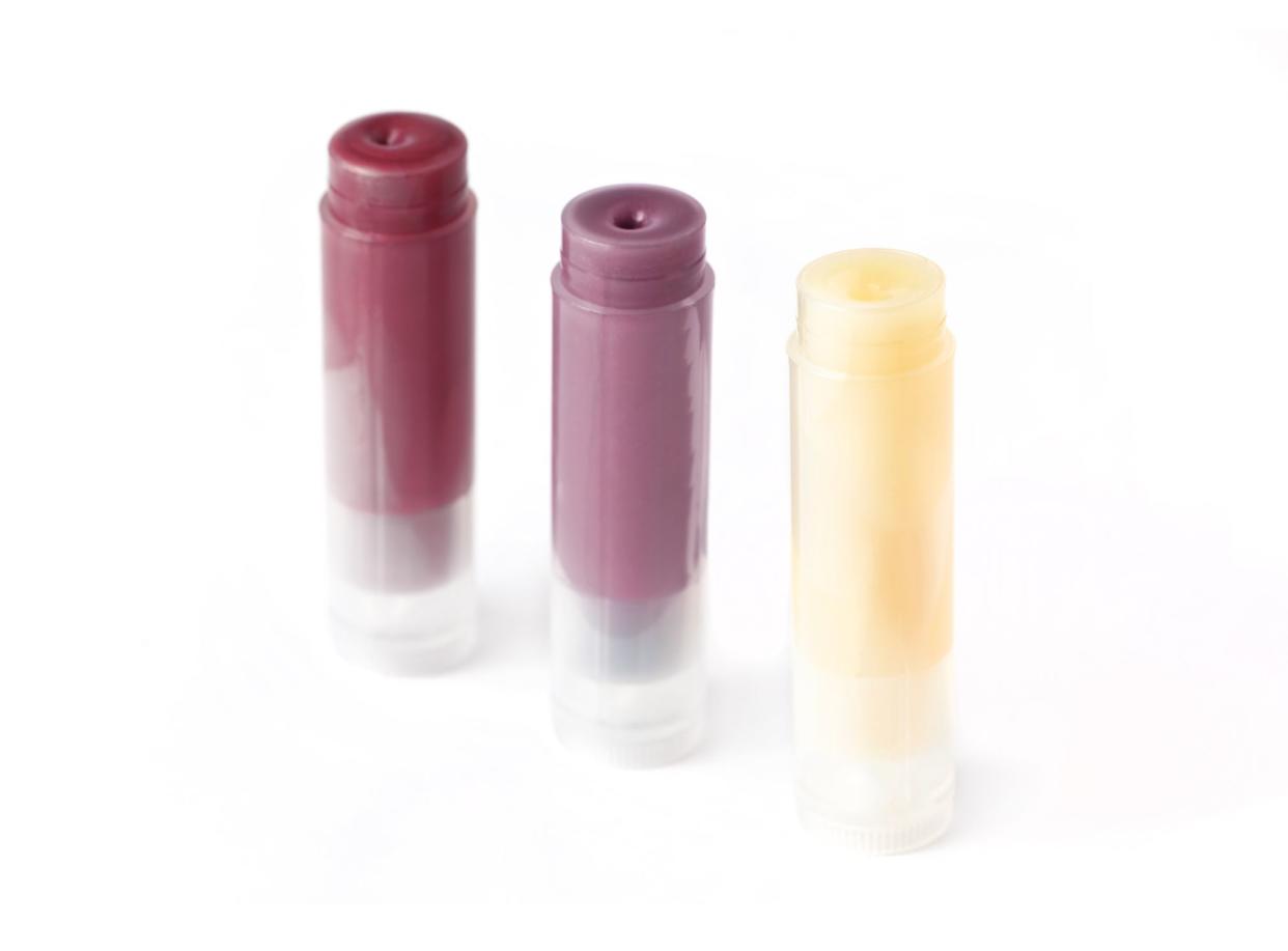 Three sticks of homemade lip balm, isolated on white. Natural organic eco cosmetics.