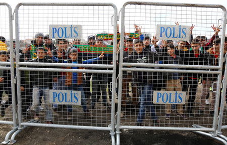 Amedspor fans gather behind security barriers before the Turkish Cup quarter final first leg soccer match between Amedspor and Fenerbahce in the Kurdish-dominated southeastern city of Diyarbakir, Turkey February 9, 2016. REUTERS/Sertac Kayar