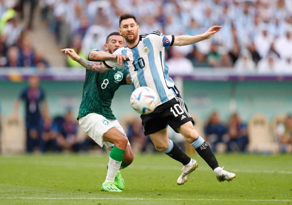 Nov 22, 2022; Lusail, Qatar; Argentina forward Lionel Messi (10) battles for the ball against Saudi Arabia midfielder Abdulellah Al-Malki (8) during a group stage match during the 2022 World Cup at Lusail Stadium. Mandatory Credit: Yukihito Taguchi-USA TODAY Sports