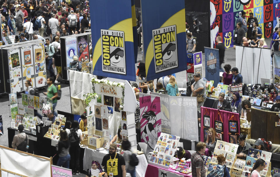 FILE - Comic-Con attendees walk the convention center floor during preview night at Comic-Con International on July 17, 2019, in San Diego, Calif. The convention will remain virtual for the July event, but organizers are planning for a smaller-scale gathering later this year. Comic-Con announced Monday, March 1, 2021, that the annual confab will return to virtual for a second-straight year between July 23-25. (Photo by Chris Pizzello/Invision/AP, File)