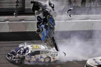 FILE - In this Feb. 17, 2020, file photo, Ryan Newman's car goes airborne after crashing into Corey LaJoie (32) during the NASCAR Daytona 500 auto race at Daytona International Speedway in Daytona Beach, Fla. NASCAR fans and fellow competitors feared the worst for Newman, but the 2008 Daytona 500 winner walked out of the hospital 48 hours later holding hands with his girls. He is a symbol of how far the sport has come since NASCAR's darkest day 20 years ago, when seven-time champion Dale Earnhardt was killed in the final turn of the 500. (AP Photo/Chris O'Meara, File)