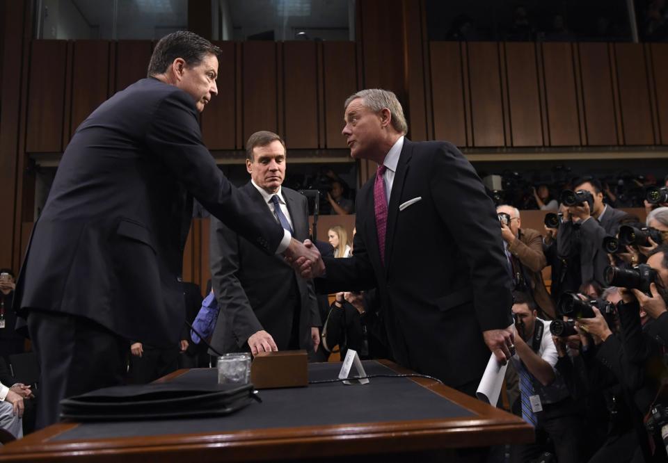 <p>Former FBI Director James Comey is welcomed by Committee Chairman Senator Richard Burr (R) and Vice Chairman Senator Mark Warner (C) to a US Senate Select Committee on Intelligence hearing on Capitol Hill in Washington, D.C., June 8, 2017. (Photo: Saul Loeb/AFP/Getty Images) </p>