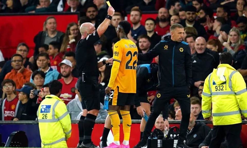 Gary O'Neil (right) is shown a yellow card by referee Simon Hooper