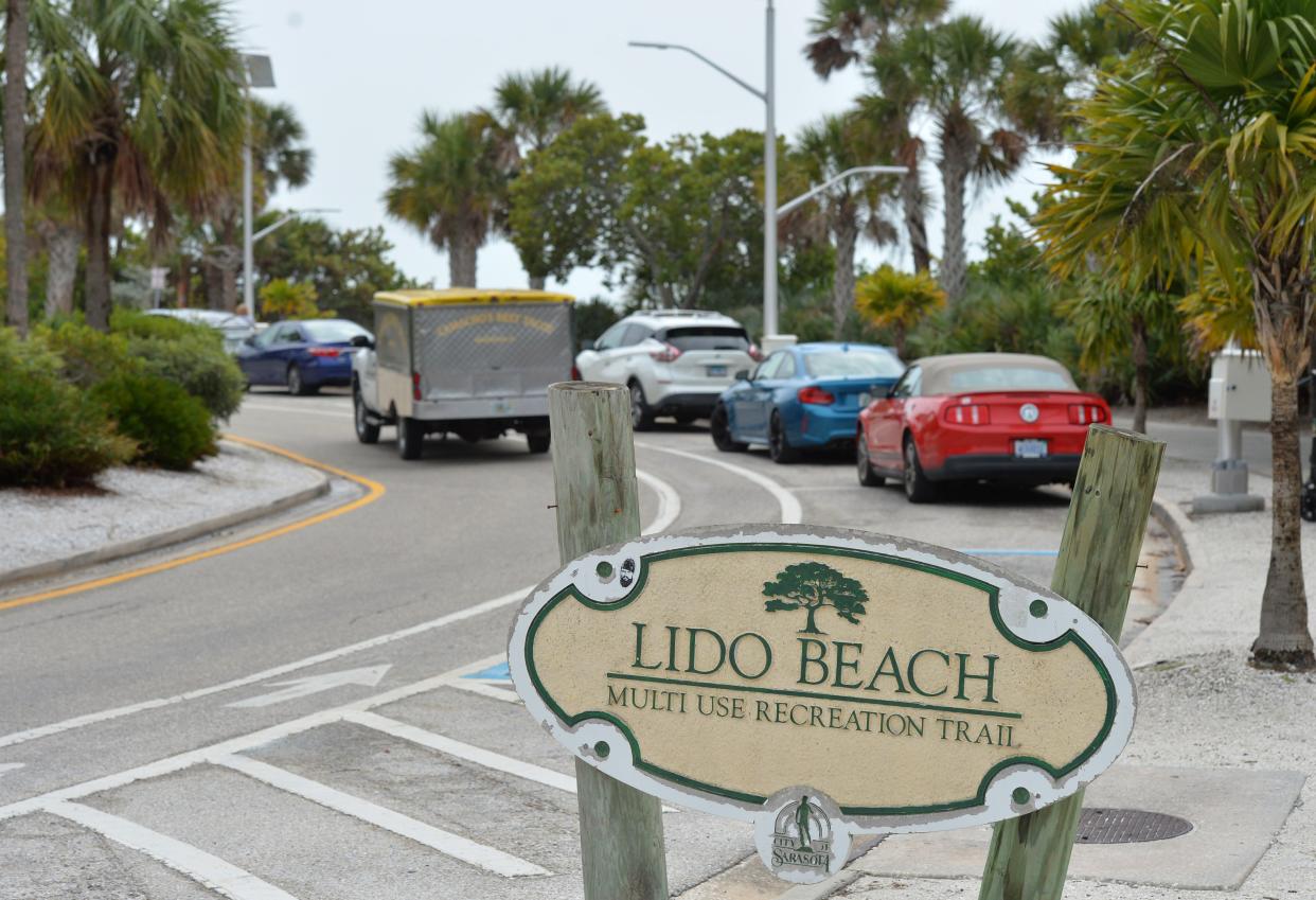 Drivers take advantage of free parking along Benjamin Franklin Drive next to Lido Beach in Sarasota.