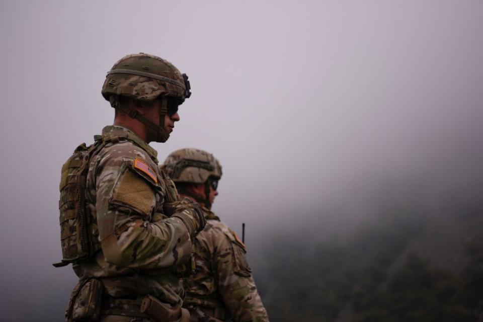 US NATO soldiers patrol near the border between Kosovo and Serbia in Jarinje as Serbs remove trucks and cars that used to block the border with Kosovo. 