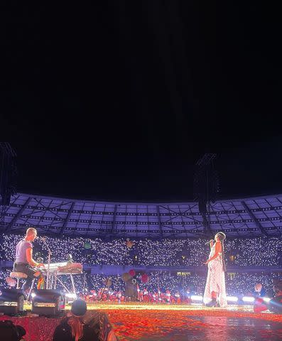 <p>Griff/ Instagram</p> Griff on stage with Chris Martin during Coldplay's 'Music of the Spheres' world tour