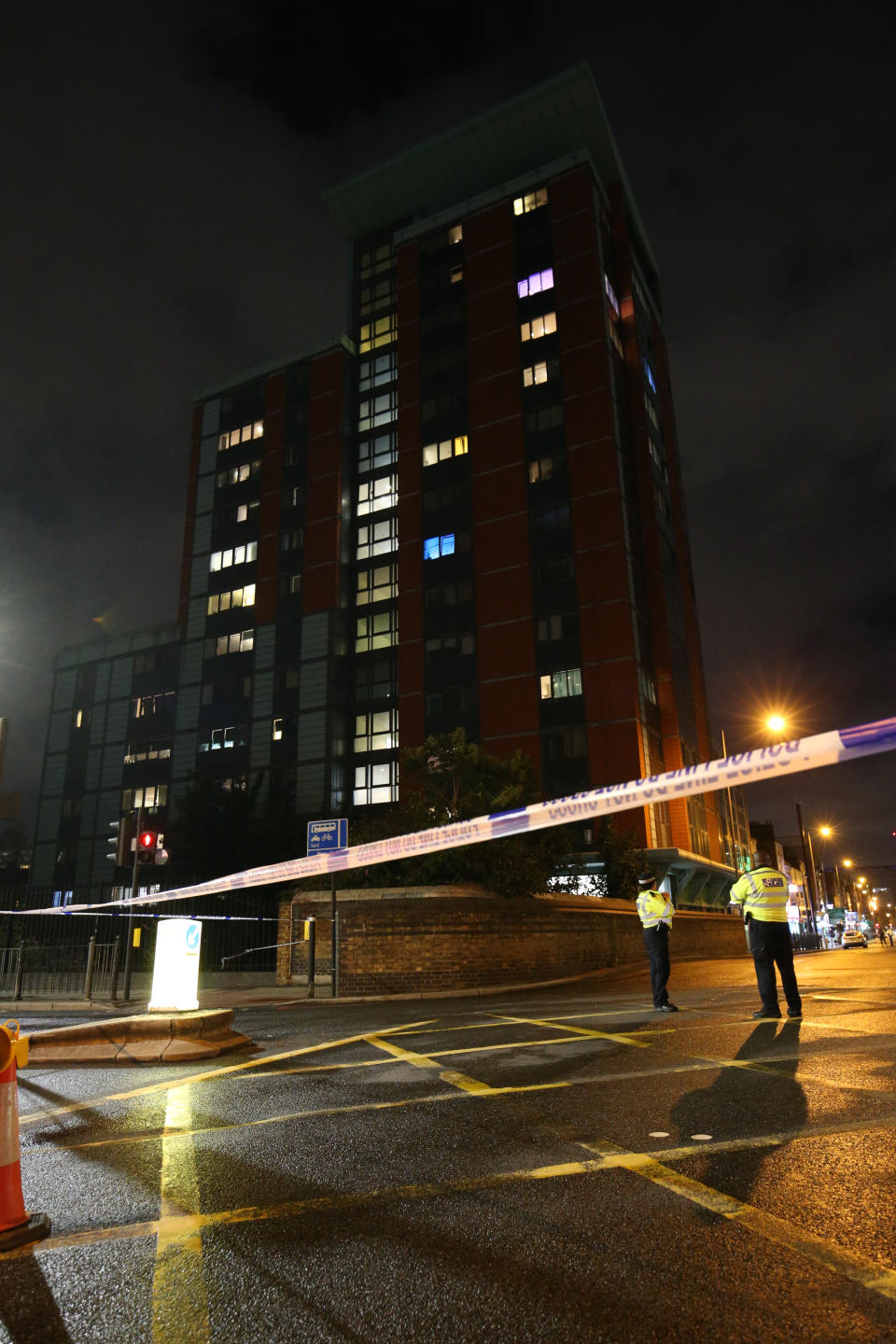 Police cordon at the junction of Chrisp Street and East India Dock Road (A13), Poplar in London, after a toddler was taken to hospital after falling from a block of flats in east London. The Metropolitan police have not confirmed the block of flats, but said they were called to East India Dock Road in Poplar shortly after 6.50pm on Monday to reports that a child had "fallen from height."