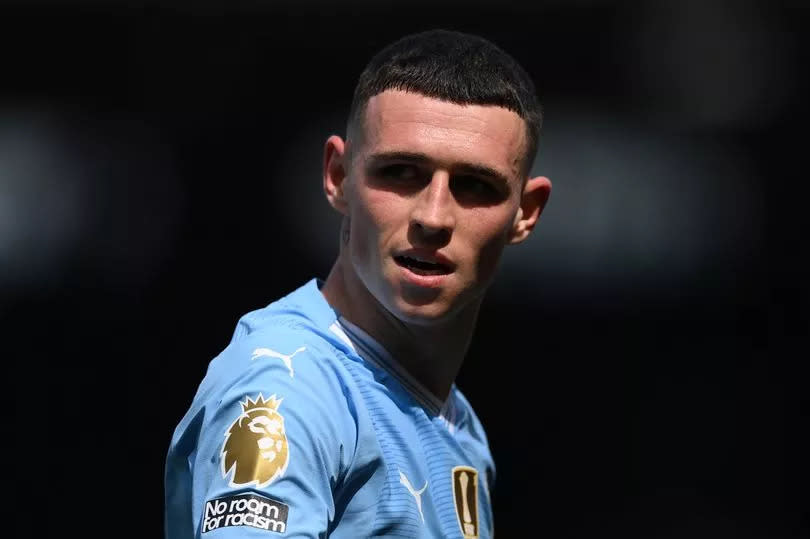 Phil Foden looks on