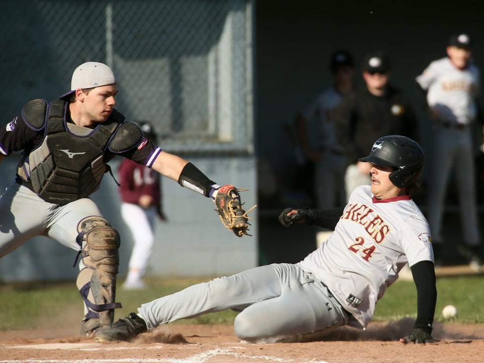 Liberty Christian's Evan Dupler slides home plate as Granville Christian's Jake Fabbro reaches for the tag on Thursday.