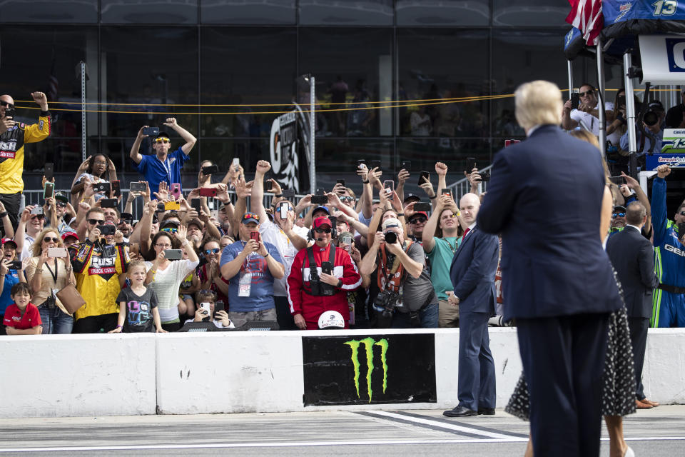 People cheer as President Donald Trump and first lady Melania Trump arrive before the start of the NASCAR Daytona 500 auto race at Daytona International Speedway, Sunday, Feb. 16, 2020, in Daytona Beach, Fla. (AP Photo/Alex Brandon)