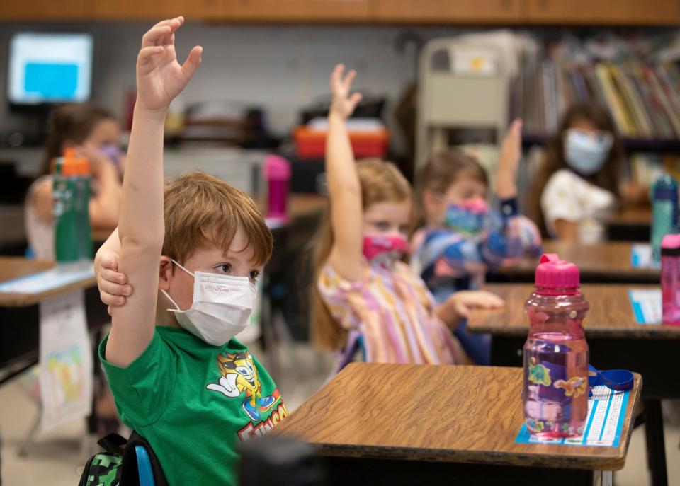 First-grader Killian Ernst raises his hand during class to share his wish at J.F. Burns Elementary, Aug. 31, 2021. Ernst told his teacher, Julie Fischer, his wish was to make the world a better place. Fischer teaches the Character Effect, an evidence-based program developed by Beech Acres Parenting Center. It is a social-emotional intelligence program that helps kids with resilience by identifying their own positive character traits and those of others.