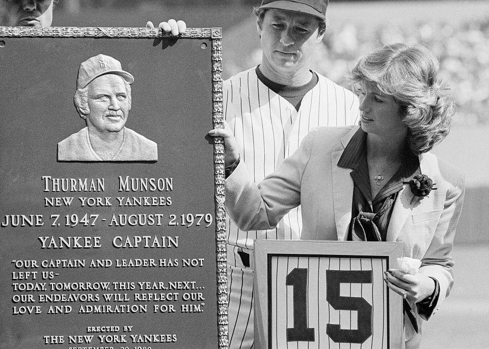 A plaque dedicated to the late New York Yankee catcher Thurman Munson is viewed by his widow Diana and Yankee outfield Bobby Murcer during ceremonies before the game with the Boston Red Sox at Yankees Stadium, Sept. 20, 1980.