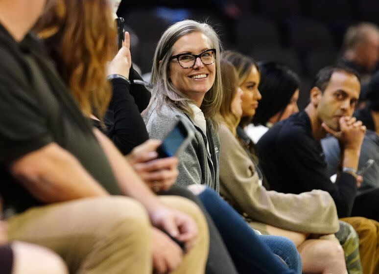 Arizona Governor-elect Katie Hobbs enjoys an NBA basketball game between the Phoenix Suns and Washington Wizards in Phoenix, Tuesday, Dec. 20, 2022. (AP Photo/Darryl Webb)