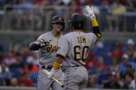 Pittsburgh Pirates' Kevin Newman, left, celebrates after hitting a home run with teammate Ka'ai Tom during the first inning of a baseball game against the Washington Nationals, Monday, June 14, 2021, in Washington. (AP Photo/Carolyn Kaster)