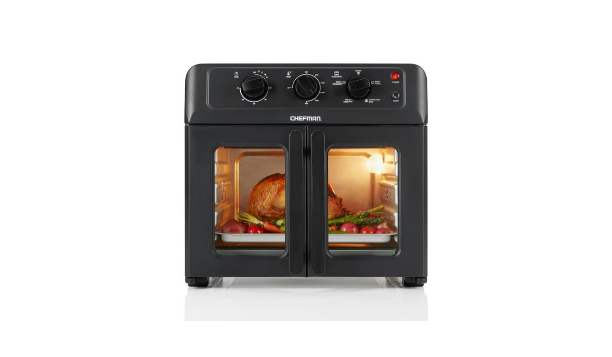 Glass-paned French door air fryer with knobs on top panel and rotisserie chicken shown inside. 