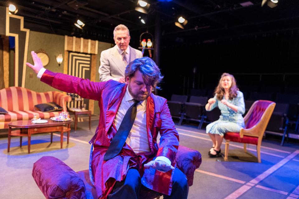 Robert Tombari, foreground, plays Garry Essendine, Lee Lodyga plays Morris Dixon and Abbey Platt plays Liz Essendine in South Bend Civic Theatre's production of Noël Coward's "Present Laughter" that opens Feb. 10 and continues through Feb. 19, 2023, at the theater in downtown South Bend.